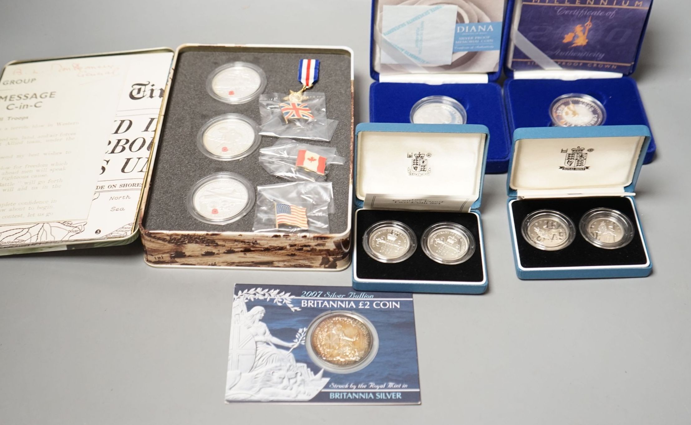 Cased Royal Mint UK proof coins – a Diana Memorial silver coin, a Millennium £5, a D-day 3 coin silver medal set, a 1992 two coin 10p set and a 1989 two coin £2 set